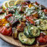 Vibrant roasted eggplant, zucchini, bell peppers, and cherry tomatoes for Roasted Mediterranean Greek Vegetables, drizzled with lemon and olive oil.