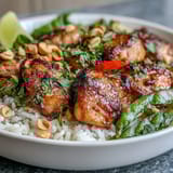 Fragrant Thai Chicken Coconut Bowl with fluffy coconut rice and juicy chicken, topped with crisp veggies and fresh herbs.