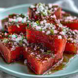 Watermelon wedges sprinkled with spicy Tajin and drizzled with lime juice create the perfect sweet-and-sour beach treat.  