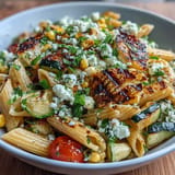 Smoky zucchini, sweet corn pasta salad topped with tangy Cotija cheese.