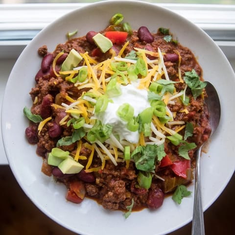 Bubbling pot of homemade Chili con Carne with kidney beans and peppers for dinner.