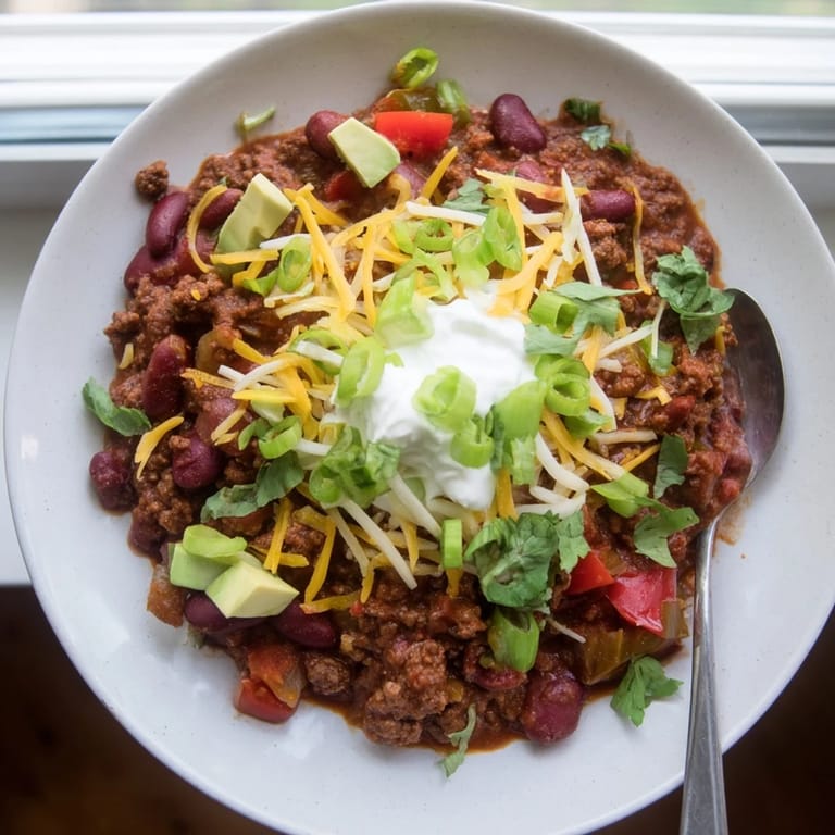 Bubbling pot of homemade Chili con Carne with kidney beans and peppers for dinner.