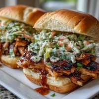 4th of July BBQ Chicken Sliders with Coleslaw piled high with smoky pulled chicken and tangy coleslaw on soft toasted buns.