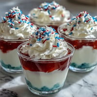 Vibrant 4th of July Firecracker Jello Shots glow with fruity, layered goodness.